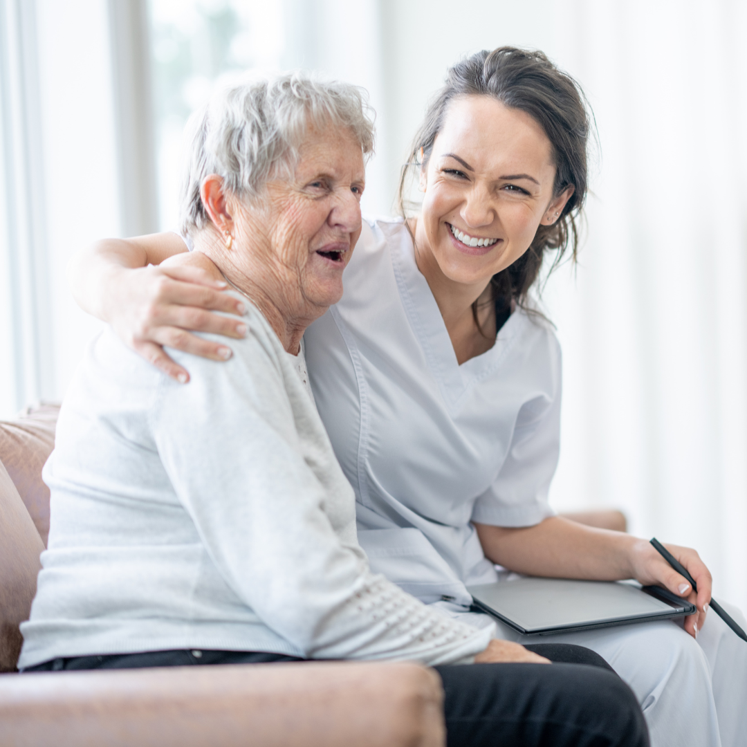 Happy client with smiling Columbia senior caregiver
