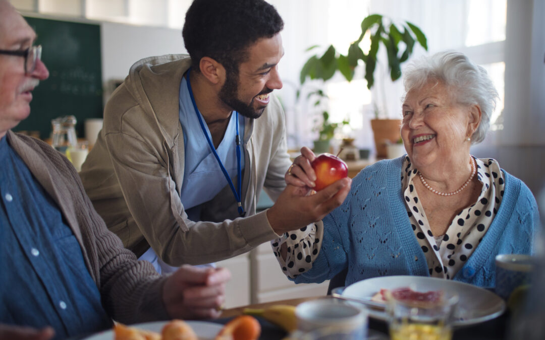 Caregiver providing private home care services in the Greater Columbia area, supporting an elderly client with daily tasks.